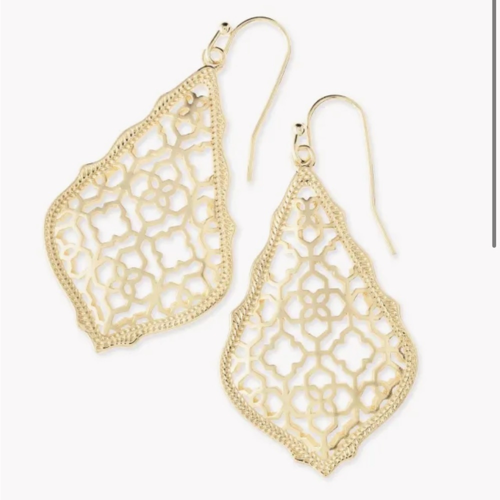 Kendra Scott Addie gold drop earrings.